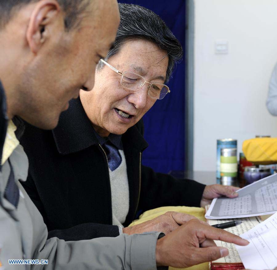 Scholars study Palm-Leaf Manuscripts of Buddhist Sutras in Lhasa, capital of southwest China's Tibet Autonomous Region, Nov. 21, 2012. The palm-leaf manuscripts of Buddhist sutras have been well preserved in China. Palm-Leaf sutras refer to the Buddhist classics inscribed on the leaves of palm trees. The practice originated in India and was introduced into China more than 1,000 years ago during the Tang Dynasty (618-907).(Xinhua/Chogo) 