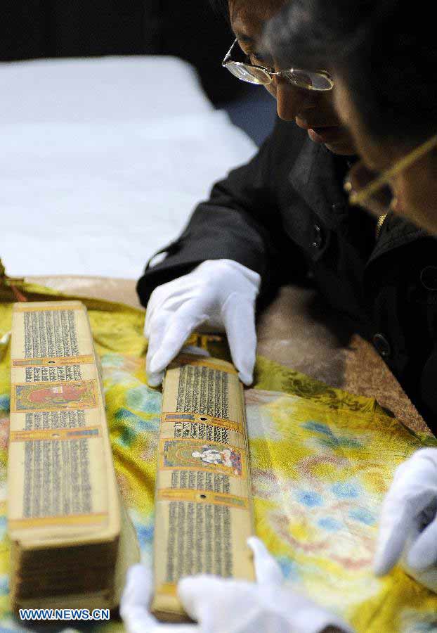 Scholars study Palm-Leaf Manuscripts of Buddhist Sutras in Lhasa, capital of southwest China's Tibet Autonomous Region, Nov. 21, 2012. The palm-leaf manuscripts of Buddhist sutras have been well preserved in China. Palm-Leaf sutras refer to the Buddhist classics inscribed on the leaves of palm trees. The practice originated in India and was introduced into China more than 1,000 years ago during the Tang Dynasty (618-907).(Xinhua/Chogo)