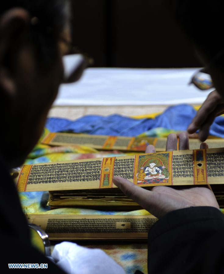 Scholars study Palm-Leaf Manuscripts of Buddhist Sutras in Lhasa, capital of southwest China's Tibet Autonomous Region, Nov. 21, 2012. The palm-leaf manuscripts of Buddhist sutras have been well preserved in China. Palm-Leaf sutras refer to the Buddhist classics inscribed on the leaves of palm trees. The practice originated in India and was introduced into China more than 1,000 years ago during the Tang Dynasty (618-907).(Xinhua/Chogo)