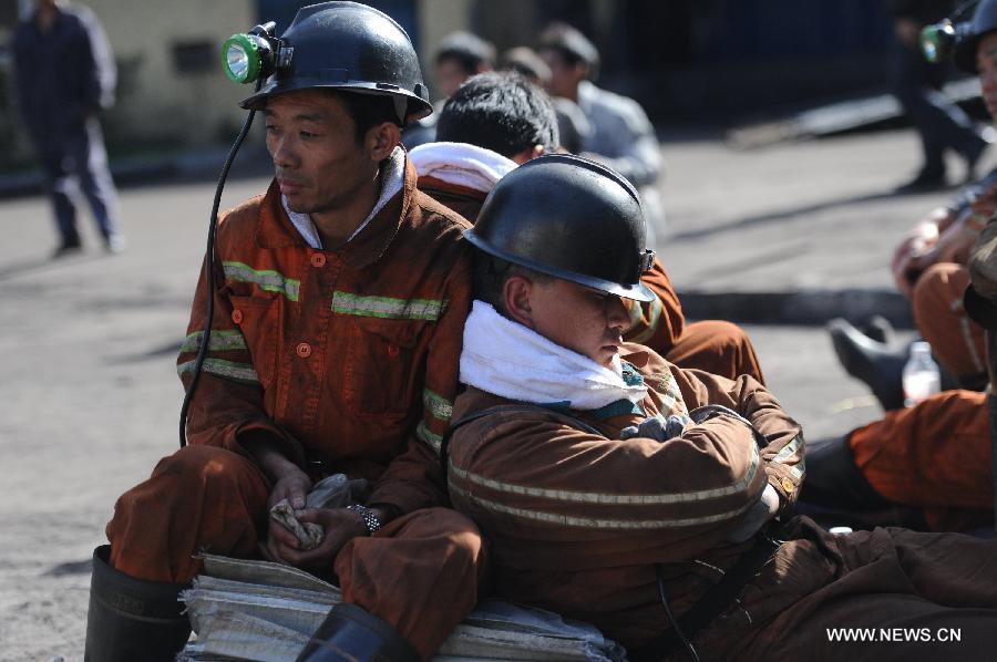 Rescuers take a rest before entering the shaft to continue rescue work at the Xiangshui Coal Mine in Panxian County of Liupanshui City, southwest China's Guizhou Province, Nov. 25, 2012. Nineteen miners were confirmed dead, and four others remain trapped after a coal-gas outburst hit the Xiangshui Coal Mine at 10:55 a.m. on Saturday.(Xinhua/Tao Liang) 