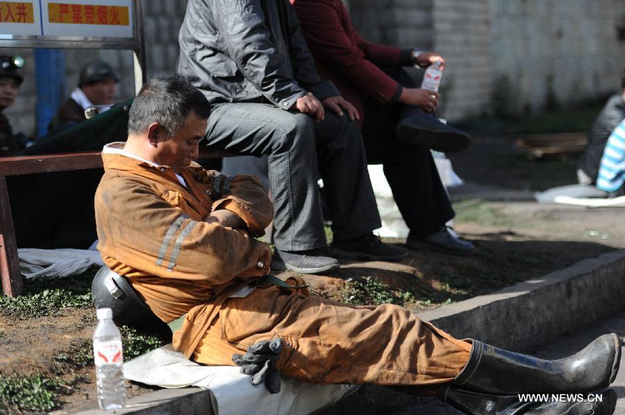 Rescuers take a rest before entering the shaft to continue rescue work at the Xiangshui Coal Mine in Panxian County of Liupanshui City, southwest China's Guizhou Province, Nov. 25, 2012. Nineteen miners were confirmed dead, and four others remain trapped after a coal-gas outburst hit the Xiangshui Coal Mine at 10:55 a.m. on Saturday.(Xinhua/Tao Liang) 