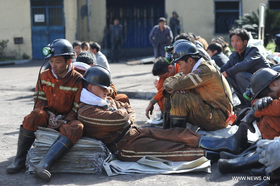 Rescuers take a rest before entering the shaft to continue rescue work at the Xiangshui Coal Mine in Panxian County of Liupanshui City, southwest China's Guizhou Province, Nov. 25, 2012. Nineteen miners were confirmed dead, and four others remain trapped after a coal-gas outburst hit the Xiangshui Coal Mine at 10:55 a.m. on Saturday.(Xinhua/Tao Liang) 