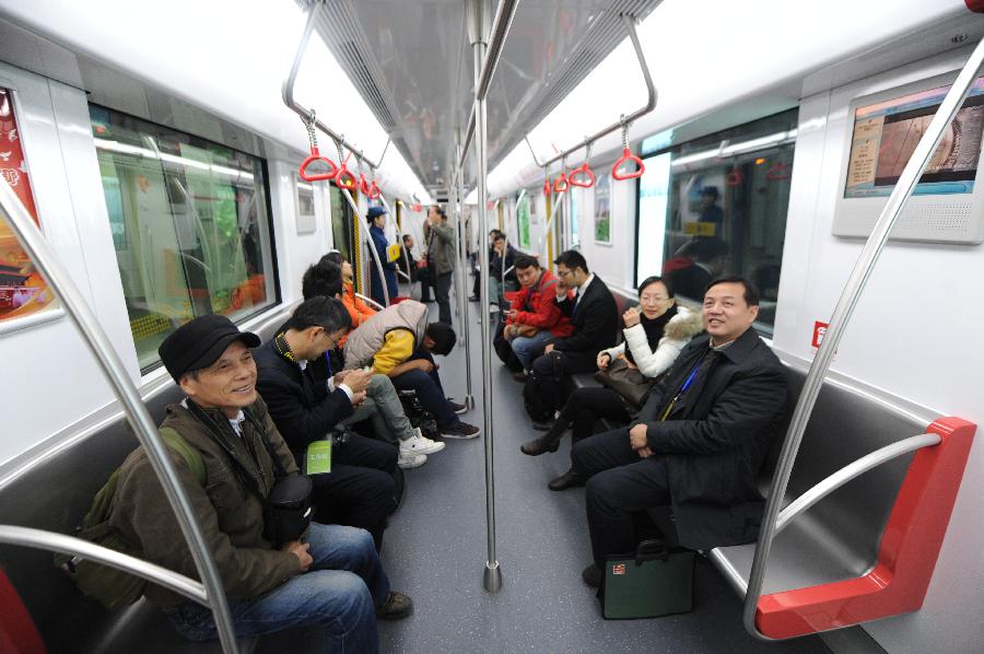 Passengers take the Hangzhou Subway Line 1 in Hangzhou, capital of east China's Zhejiang Province, Nov. 24, 2012. Hangzhou Subway Line 1, the first subway in Zhejiang covering a distance of 47.97 kilometers, was put into a trial operation on Saturday after five years of construction. (Xinhua/Huang Zongzhi) 