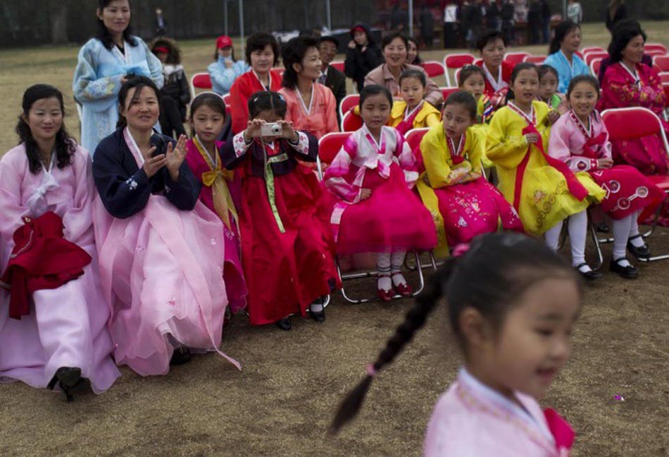 A girl takes a photo of her friend who is dancing. (Photo/Xinhua)