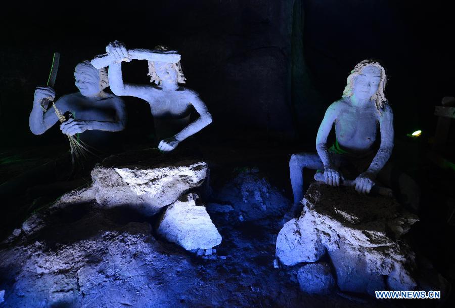 Photo taken on Nov. 26, 2012 shows the sculptures imitating ancient people's life at the Xianren Cave in Dayuan Township of Wannian County, east China's Jiangxi Province. Xianren Cave is the location for historically important finds of prehistoric pottery sherds and rice remains. (Xinhua/Zhou Ke) 