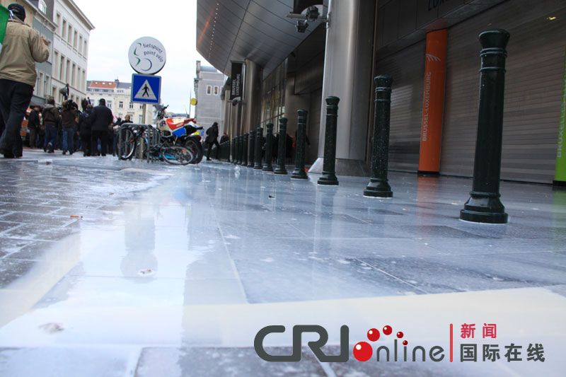 Milk flows over the ground during a protest against E.U. agricultural policies at the Place du Luxembourg in Brussels, Belgium, Nov. 26, 2012. Dairy farmers from all over Europe demonstrated in Brussels on Monday to protest against falling milk prices caused by overproduction in the continent. (Photo/CRI Online)