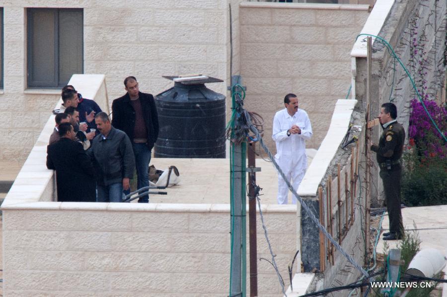 Palestinian security officers stand guard at the tomb housing late Palestinian leader Yasser Arafat, in the West Bank city of Ramallah, on Nov. 27, 2012. The remains of the late Palestinian leader Yasser Arafat were reburied on Tuesday after samples were taken to be tested for signs he was poisoned, Palestinian sources said. (Xinhua/Chen Xu)