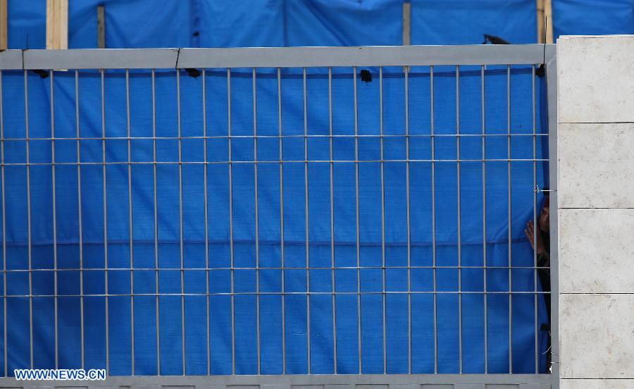 A Palestinian policeman looks out from the mausoleum housing late Palestinian President Yasser Arafat, in the West Bank city of Ramallah, on Nov. 27, 2012. Earlier Tuesday, the PNA finalized digging up the remains of Arafat, as Russian, Swiss and French experts took samples of the remains to inspect the reason behind his death. (Xinhua/Ayman Nobani)