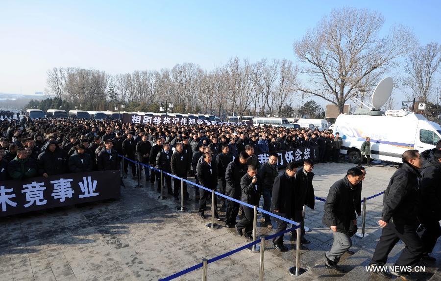 People attend a memorial service for Luo Yang, head of the production phase for China's new J-15 fighter jet, who died of a heart attack on Nov. 25, in the Huilonggang Cemetery for Revolutionaries in Shenyang, capital of northeast China's Liaoning Province, Nov. 29, 2012. Luo experienced a heart attack after observing aircraft carrier flight landing tests for China's first aircraft carrier, the Liaoning, on Nov. 25. He later died in hospital at the age of 51. He was also chairman and general manager of Shenyang Aircraft Corp. (SAC), a subsidiary of China's state-owned aircraft maker, Aviation Industry Corp. of China (AVIC). (Xinhua/Yang Qing) 