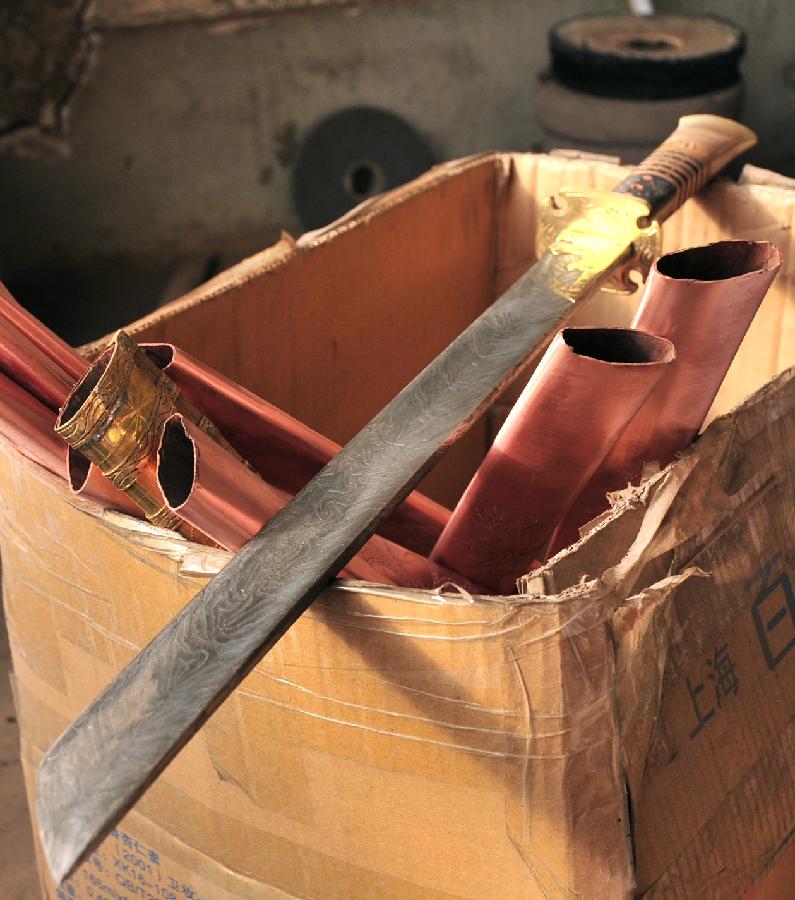 Photo taken on Nov. 29, 2012 shows a box of semi-finished Bao'an broadswords and sheaths in Jishishan County, northwest China's Gansu Province. (Xinhua/Huang Wenxin) 