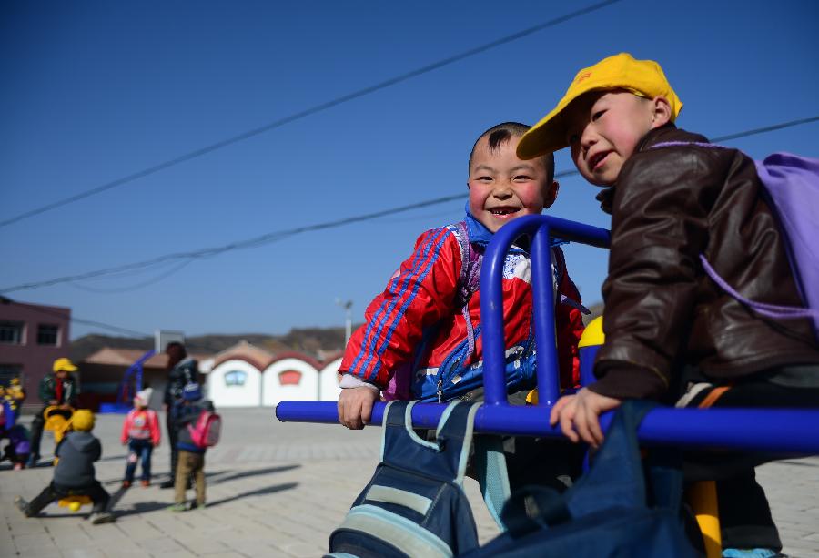 Children play on the fitness equipment at a cultural square in Maxia Village of Huating County, northwest China's Gansu Province, Nov. 28, 2012. The coal-rich county once suffered from environment degradation due to exploitation of natural resources. Great efforts have been made in recent years to repair the environment, and now the county has turned to be a liveable place with clean air and beautiful gardens. (Xinhua/Zhang Meng) 