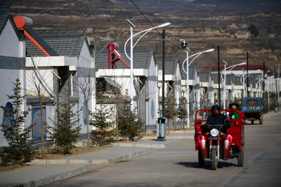 Photo taken on Nov. 28, 2012 shows the new houses for resettlement of farmers at Yanxia Township in Huating County, northwest China's Gansu Province. The coal-rich county once suffered from environment degradation due to exploitation of natural resources. Great efforts have been made in recent years to repair the environment, and now the county has turned to be a liveable place with clean air and beautiful gardens. (Xinhua/Zhang Meng) 