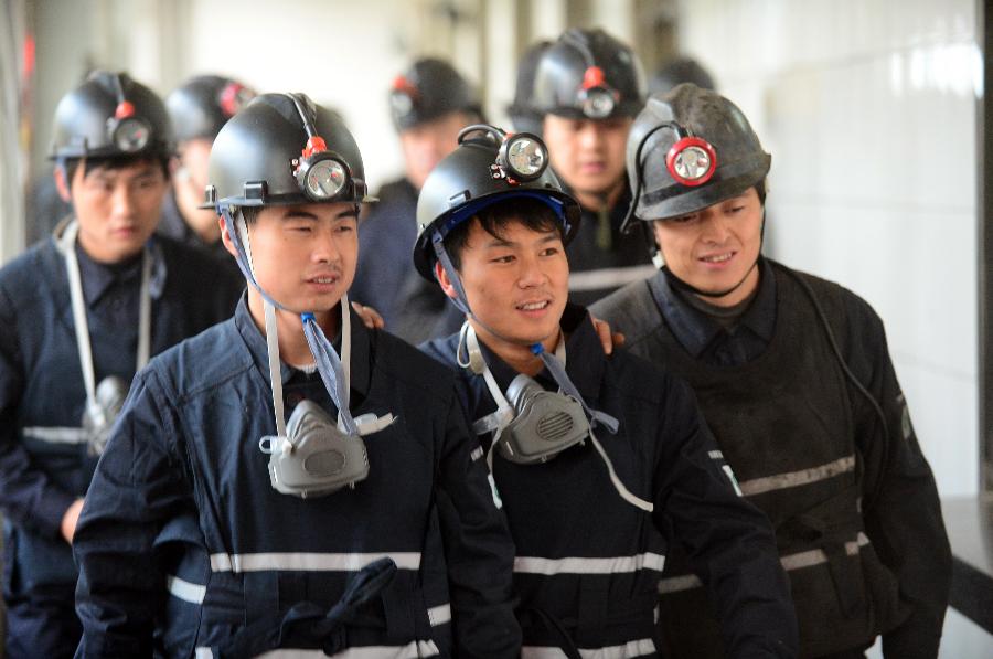 Miners prepare to start work at the Huating Coal Mine in Huating County, northwest China's Gansu Province, Nov. 29, 2012. The coal-rich county once suffered from environment degradation due to exploitation of natural resources. Great efforts have been made in recent years to repair the environment, and now the county has turned to be a liveable place with clean air and beautiful gardens. (Xinhua/Zhang Meng) 