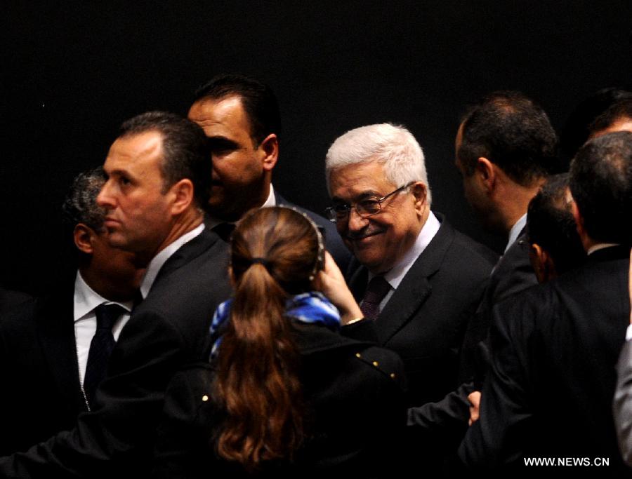 Palestinian President Mahmoud Abbas (C) gets congratulations at the UN General Assembly (UNGA) meeting at the UN headquarters in New York, the United States, on Nov. 29, 2012. The UNGA on Thursday voted overwhelmingly to grant an upgrade of the Palestinians status at the United Nations from "entity" to "non-member state". (Xinhua/Shen Hong)