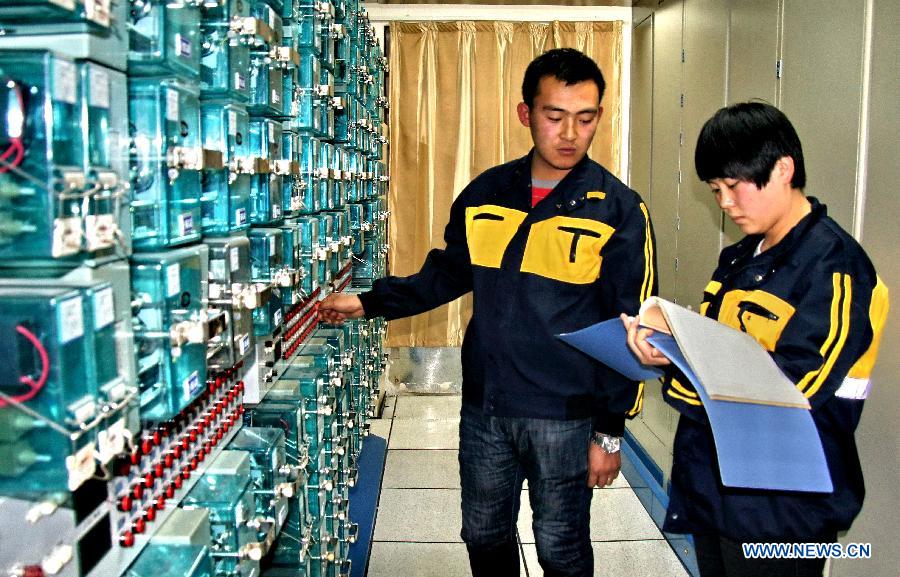 Technicians check devices at the signal mechanical room of the Baotou East Station of the Baotou electricity section of the Hohhot Railway Bureau in Baotou, north China's Inner Mongolia Autonomous Region, Nov. 29, 2012. Facing the low temperatures, strong winds and snowfalls since winter, the Hohhot Railway Bureau has organized all its departments to guarantee the rail transport in winter, including activities like strengthening vehicle scheduling and security inspection during on-site operations. (Xinhua/Zhao Tingting) 