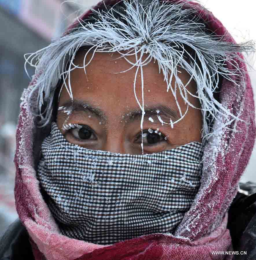 A woman is seen with ice on head in Hulun Buir, north China's Inner Mongolia Autonomous Region, Nov. 29, 2012. Snowfall and temperature drop hit the city these days. (Xinhua/Yu Changjun) 