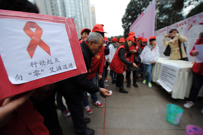 People attend a publicity activity in Chongqing on Nov. 30 to mark the World AIDS Day which falls on Dec. 1. (Xinhua)