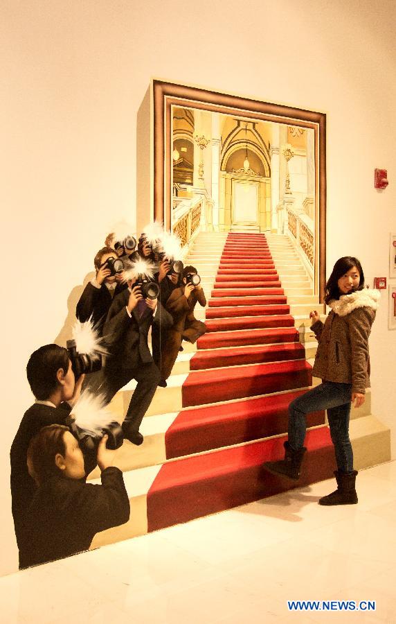 A visitor poses with a three dimensional painting during an exhibition in Tianjin, north China, Dec. 1, 2012. (Xinhua/Wang Qingyan)