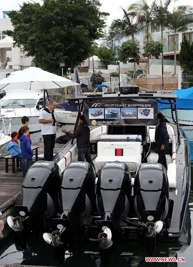 Visitors watches a yacht on display at Hong Kong International Boat Show 2012 in south China's Hong Kong, Dec. 2, 2012. The boat show closed on Sunday. (Xinhua/Li Peng) 