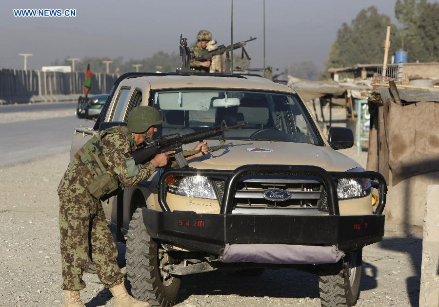 Afghan soldiers keep watch at the site of an attack in Nangarhar Province, Afghanistan, on Dec. 2, 2012. At least 11 people were killed when several Taliban militants armed with suicide vests and weapons stormed an Afghan-NATO base in Jalalabad, the capital city of Afghanistan's eastern province of Nangarhar Sunday morning. (Xinhua/Tahir Safi)