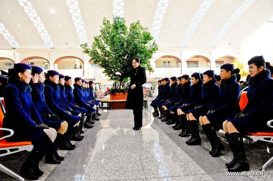 Attendants of a high-speed train make preparations for their work at the Harbin West Railway Station in Harbin, capital of northeast China's Heilongjiang Province, Dec. 1, 2012. The world's first high-speed railway in areas with extremely low temperature, which runs through three provinces in northeastern China, started operation on Saturday. The railway links Harbin, capital of Heilongjiang Province, and Dalian, a port city in Liaoning Province. (Xinhua/Wang Song)