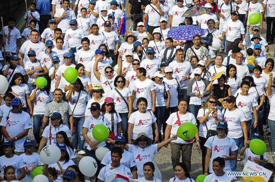 Salvadorans from different social organizations take part in a march supporting the World AIDS Day, in San Salvador, capital of El Salvador, on Dec. 1, 2012. (Xinhua/Oscar Rivera)