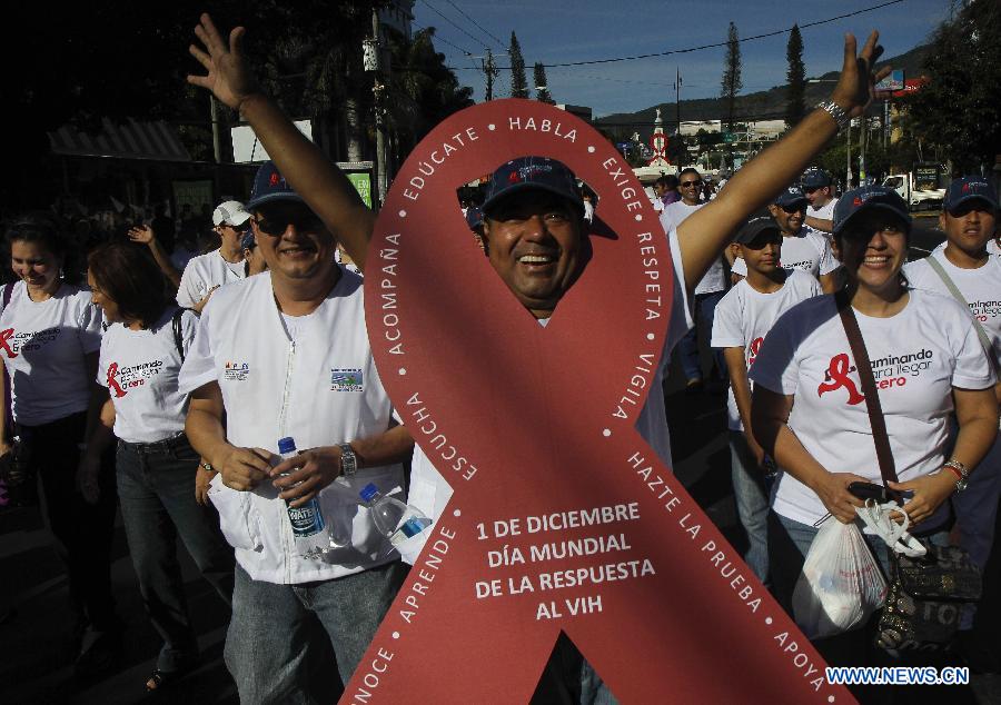 Salvadorans from different social organizations take part in a march supporting the World AIDS Day, in San Salvador, capital of El Salvador, on Dec. 1, 2012. (Xinhua/Oscar Rivera)