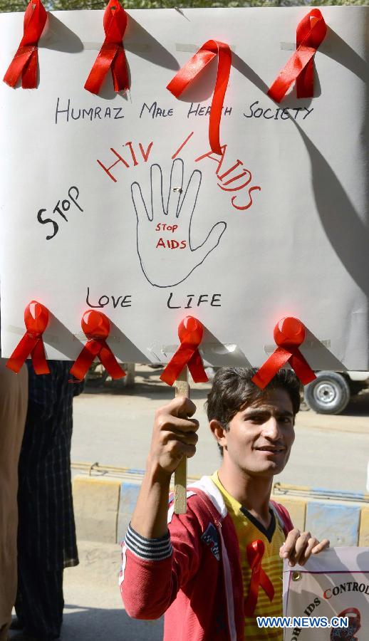 A Pakistani man holds a placarda during a rally to mark the World Aids Day in southern Pakistan's Hyderabad, Dec. 1, 2012. The World AIDS Day which is annually observed on Dec. 1, is dedicated to raising awareness of the AIDS pandemic caused by the spread of HIV infection. (Photo/Xinhua)