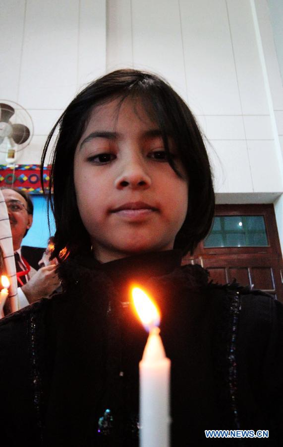 A Pakistani girl holds a candle during a ceremony to mark the World AIDS Day in southwest Pakistan's Quetta, Dec. 1, 2012. The World AIDS Day which is annually observed on Dec. 1, is dedicated to raising awareness of the AIDS pandemic caused by the spread of HIV infection. (Xinhua/Iqbal Hussain)