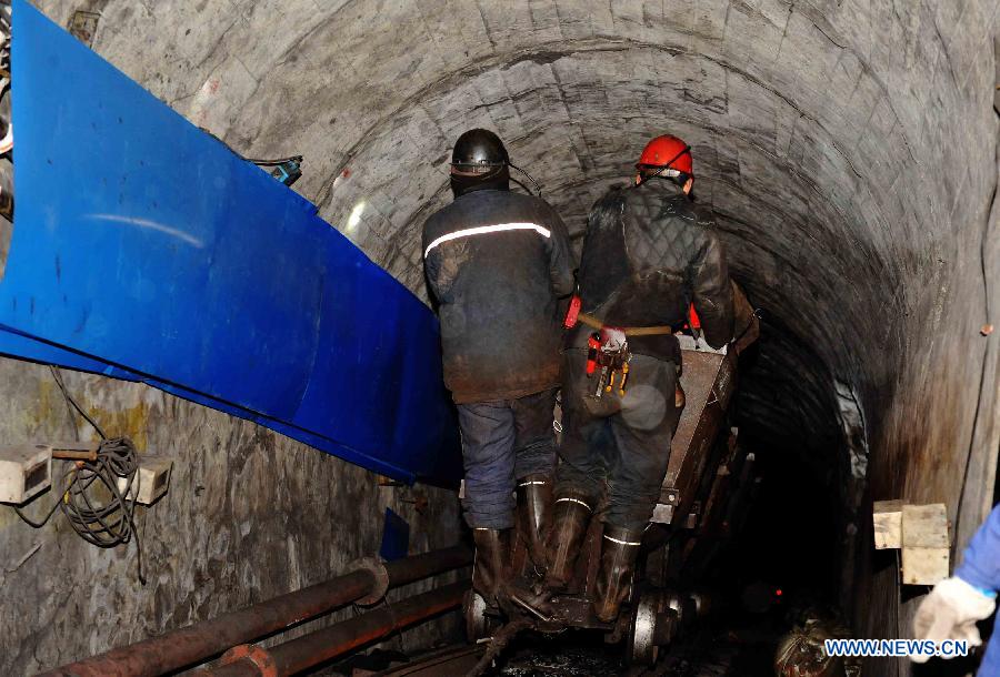 Rescuers work in the flooded mine in Qitaihe City, northeast China's Heilongjiang Province, Dec. 2, 2012. Rescuers on Sunday pulled two miners out alive while 14 others remain trapped after the Furuixiang Coal Mine in Qitaihe City was flooded on Saturday, according to local government sources. (Xinhua/Wang Jianwei) 