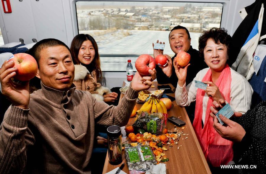 Passengers enjoy their trip on a high-speed train from Harbin, capital of northeast China's Heilongjiang Province, Dec. 1, 2012. (Xinhua/Wang Song)