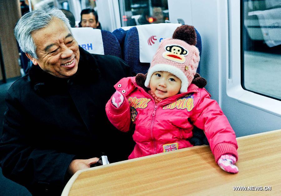 Passengers sit in a high-speed train at the Harbin West Railway Station in Harbin, capital of northeast China's Heilongjiang Province, Dec. 1, 2012. (Xinhua/Wang Song) 