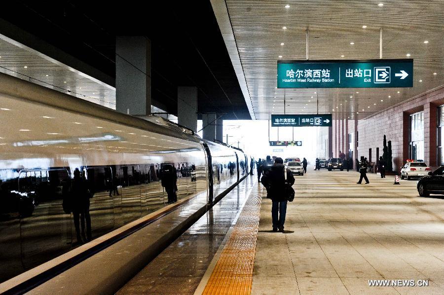 A passenger prepares to board a high-speed train at the Harbin West Railway Station in Harbin, capital of northeast China's Heilongjiang Province, Dec. 1, 2012.  (Xinhua/Wang Song)