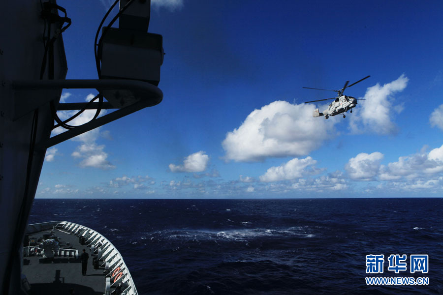 A fleet of the Navy of the Chinese People's Liberation Army (PLA) conducts search and rescue drills with a helicopter, in the western Pacific Ocean on December 1, 2012. (Xinhua/Sun Yanxin)