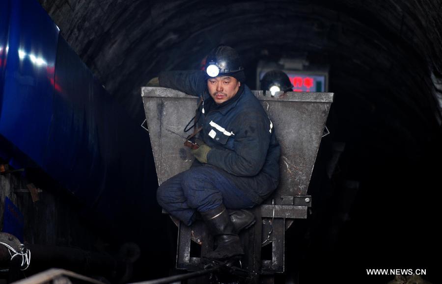 A rescuer takes a tramcar after installing water pumps at the Furuixiang Coal Mine in Qitaihe City, northeast China's Heilongjiang Province, Dec. 3, 2012. (Xinhua/Wang Jianwei)  