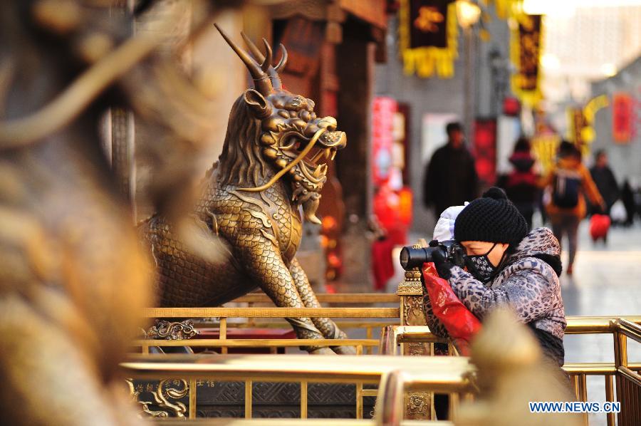 Tourists visit the Tianhou Temple in north China's Tianjin Municipality, Dec. 3, 2012. The Tianhou Temple completed its repair work and was opened to society on Monday. (Xinhua/Wang Xiaoming) 