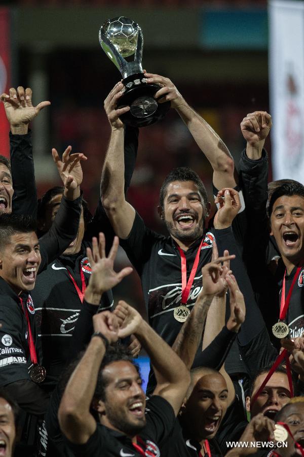 Players of Tijuana celebrate their victory over Toluca after their Mexican Apertura tournament final football match, at Nemesio Diez stadium, in Toluca, Mexico, on Dec. 2, 2012. (Xinhua/David de la Paz)