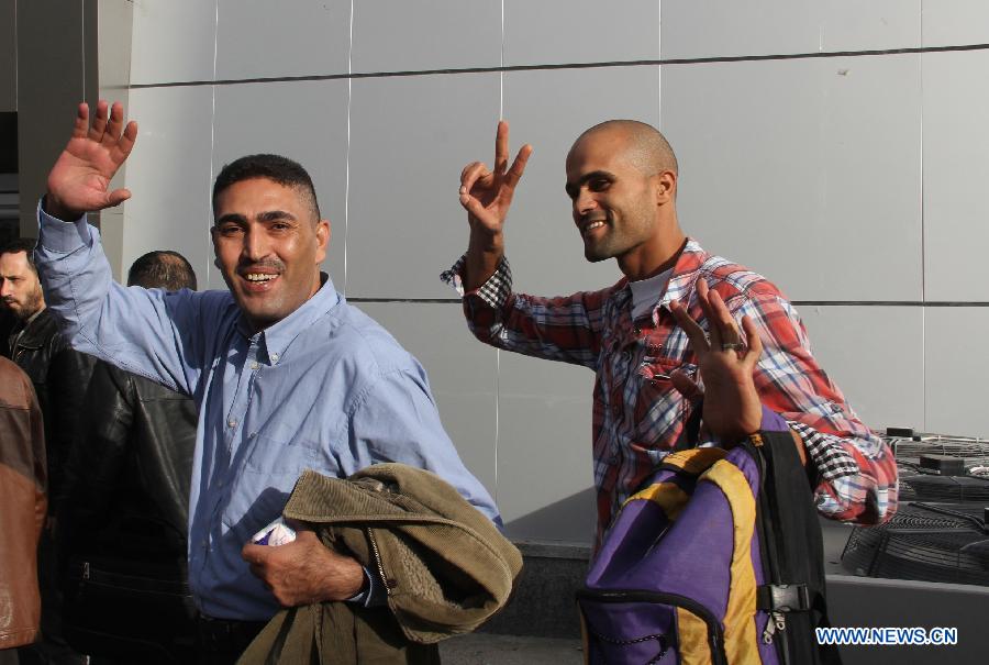 Members of Fatah movement arrive at the Rafah crossing with Egypt in the southern Gaza Strip, on Dec. 3, 2012. A total of 11 members of Palestinian Fatah movement, who fled Gaza into Egypt in 2007 during internal fighting between the two political rivals, returned home on Monday following an amnesty by the Hamas ruling government. (Xinhua/Khaled Omar) 