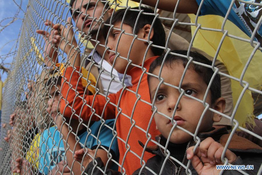 Palestinian children wait for the return of members of Fatah movement at the Rafah crossing with Egypt in the southern Gaza Strip, on Dec. 3, 2012. A total of 11 members of Palestinian Fatah movement, who fled Gaza into Egypt in 2007 during internal fighting between the two political rivals, returned home on Monday following an amnesty by the Hamas ruling government. (Xinhua/Khaled Omar) 