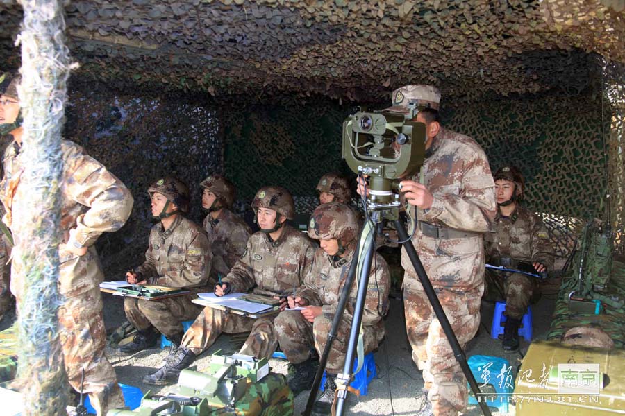 An armored brigade and a mechanized infantry brigade conduct a laser-simulation actual-troop confrontation and live-ammunition training under information conditions at the Sanjie Training Base of the Nanjing Military Area Command (MAC) on Nov. 27, 2012. (nj.81.cn/Ou Yanghao, Zuo Hailiang, Yang Kang)