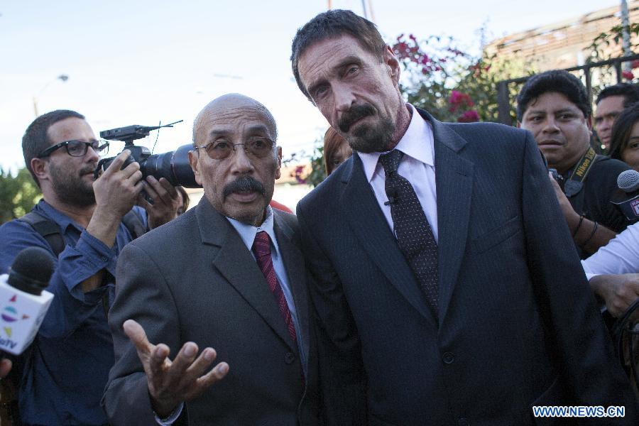 US anti-virus software pioneer John McAfee (front R) and his Guatemalan lawyer Telesforo Guerra (front L) arrive to a news conference in front of the Supreme Court in Guatemala City, capital of Guatemala, on Dec. 4, 2012. McAfee, wanted for questioning over the murder of his neighbor last month in Belize, is seeking political asylum in Guatemala, according to local media. (Xinhua/Luis Echeverria) 