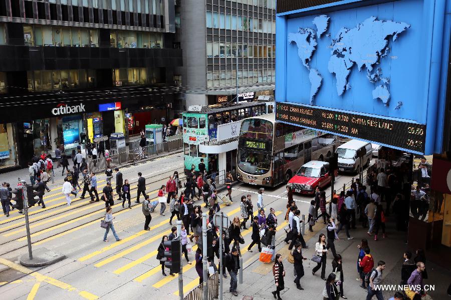 Pedestrians walk across a zebra marking near the International Financial Center (IMF) in the central district of Hong Kong, South China, Nov. 29, 2012. Hong Kong ranks first in the ranking list of China city comprehensive competitiveness released by China Institute of City Competitiveness (CICC) on Wednesday. (Xinhua/Li Peng) 