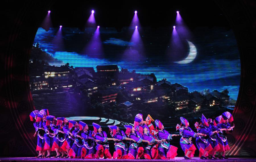 Actors perform during the minorities musical drama "Bronze Drum" in Hechi, south China's Guangxi Zhuang Autonomous Region, Dec. 3, 2012. "Bronze Drum", the bronze-drum-themed musical drama, was put on stage from Dec. 3 to Dec. 4 to show the customs and culture of the ethnic minorities along the Hongshui River. (Xinhua/Huang Xiaobang)