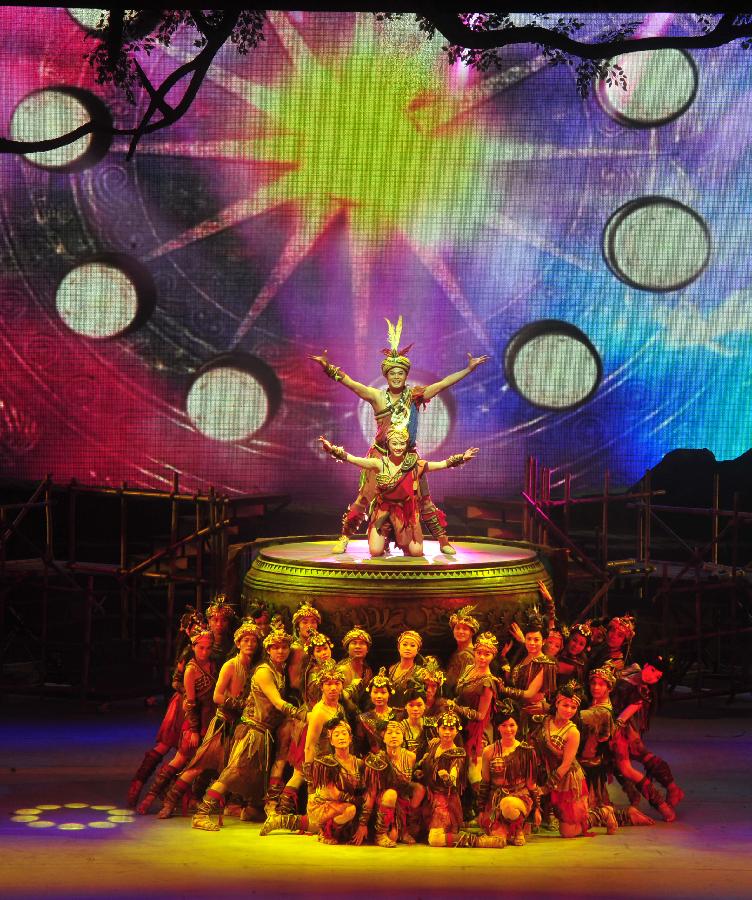 Actors perform during the minorities musical drama "Bronze Drum" in Hechi, south China's Guangxi Zhuang Autonomous Region, Dec. 3, 2012. "Bronze Drum", the bronze-drum-themed musical drama, was put on stage from Dec. 3 to Dec. 4 to show the customs and culture of the ethnic minorities along the Hongshui River. (Xinhua/Huang Xiaobang)