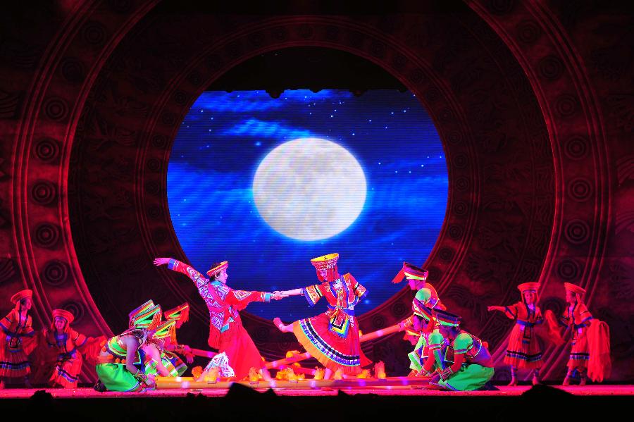 Actors perform during the minorities musical drama "Bronze Drum" in Hechi, south China's Guangxi Zhuang Autonomous Region, Dec. 3, 2012. "Bronze Drum", the bronze-drum-themed musical drama, was put on stage from Dec. 3 to Dec. 4 to show the customs and culture of the ethnic minorities along the Hongshui River. (Xinhua/Huang Xiaobang)