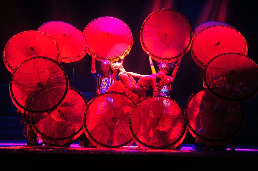 Actors perform during the minorities musical drama "Bronze Drum" in Hechi, south China's Guangxi Zhuang Autonomous Region, Dec. 3, 2012. "Bronze Drum", the bronze-drum-themed musical drama, was put on stage from Dec. 3 to Dec. 4 to show the customs and culture of the ethnic minorities along the Hongshui River. (Xinhua/Huang Xiaobang)