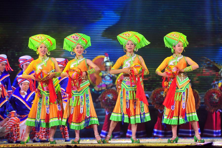 Actors perform during the minorities musical drama "Bronze Drum" in Hechi, south China's Guangxi Zhuang Autonomous Region, Dec. 3, 2012. "Bronze Drum", the bronze-drum-themed musical drama, was put on stage from Dec. 3 to Dec. 4 to show the customs and culture of the ethnic minorities along the Hongshui River. (Xinhua/Huang Xiaobang)