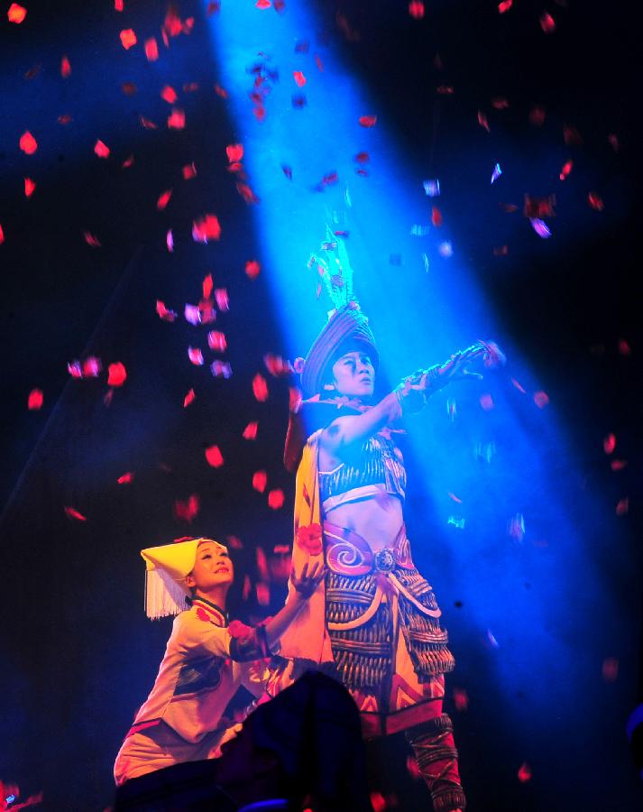 Actors perform during the minorities musical drama "Bronze Drum" in Hechi, south China's Guangxi Zhuang Autonomous Region, Dec. 3, 2012. "Bronze Drum", the bronze-drum-themed musical drama, was put on stage from Dec. 3 to Dec. 4 to show the customs and culture of the ethnic minorities along the Hongshui River. (Xinhua/Huang Xiaobang)