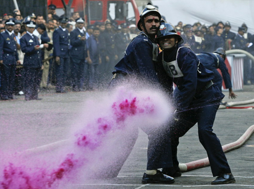 Firemen use colored water to aim at a target at the annual fire extinction competition in Bombay on Jan 9, 2012. (Reuters/Danish Siddiqui)