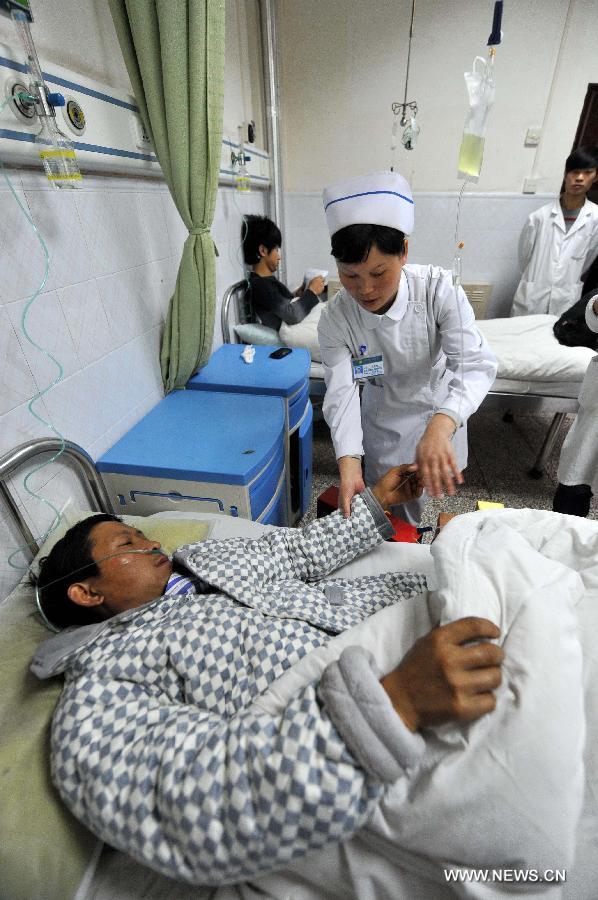 An injured miner receives medical treatment in hospital in Fuyuan County, southwest China's Yunnan Province, Dec. 6, 2012. Seventeen people have been confirmed dead and six others injured in a coal mine accident of coal and gas outburst occurred at the Shangchang Coal Mine in Huangnihe Township of Fuyuan County on Wednesday afternoon. (Xinhua/Lin Yiguang) 